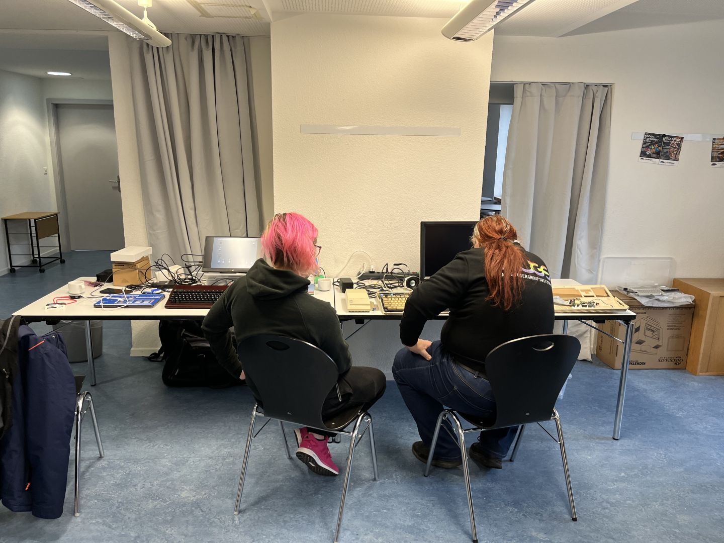Alisha ist tief in die Menüs des Checkmate Retro Monitors vertieft, während fluepke zusieht und Frag